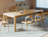 Pier Dining Table – Solid Oak – 240 cm x 100 cm paired with curved wooden dining chairs on grey rug in modern dining space.