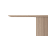 Close-up side view of 4 to 5 seater round dining table in natural American ash finish.