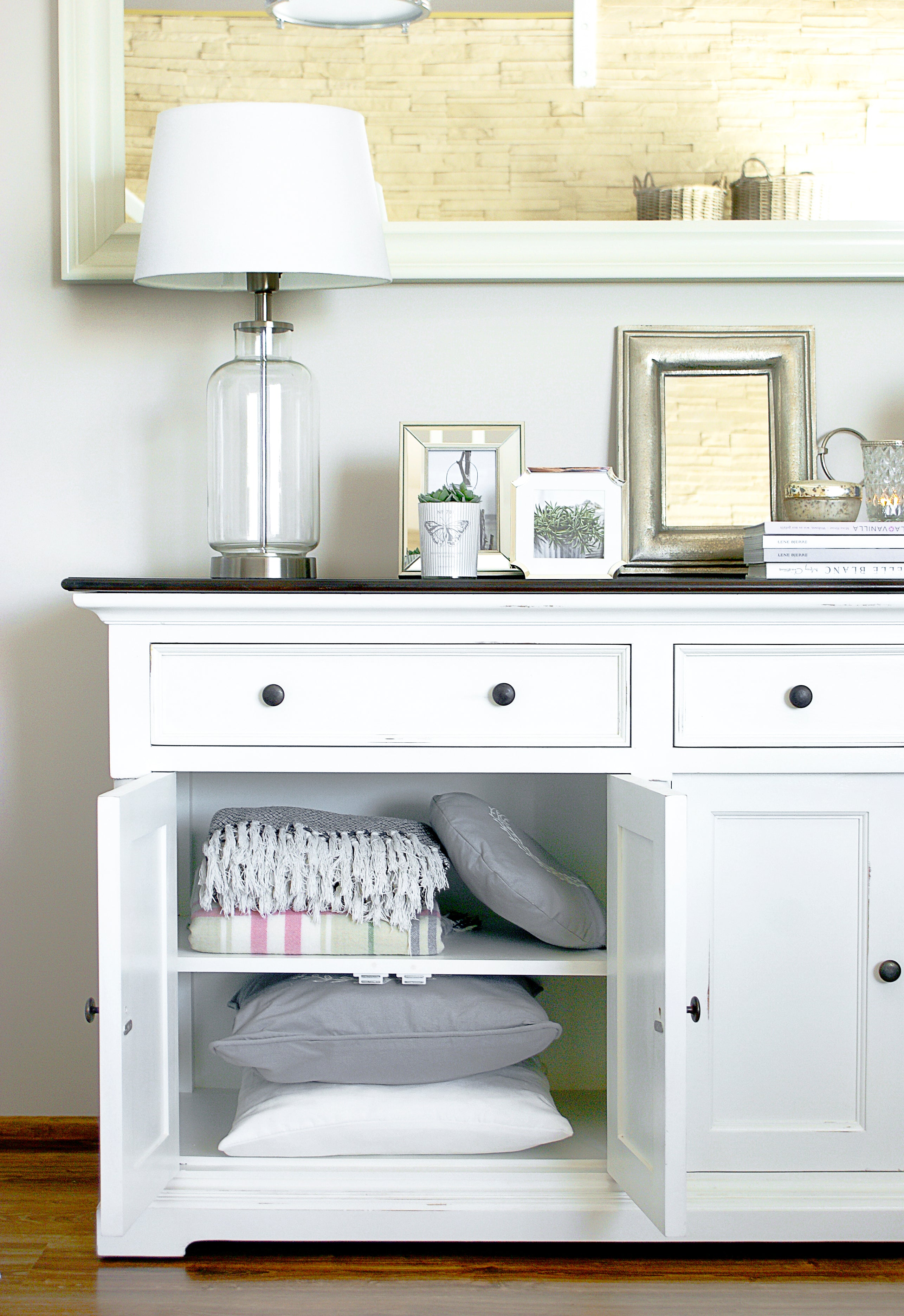 Close-up of the Provence Accent Classic Buffet storage space with open doors, shelves, cushions and soft furnishings.