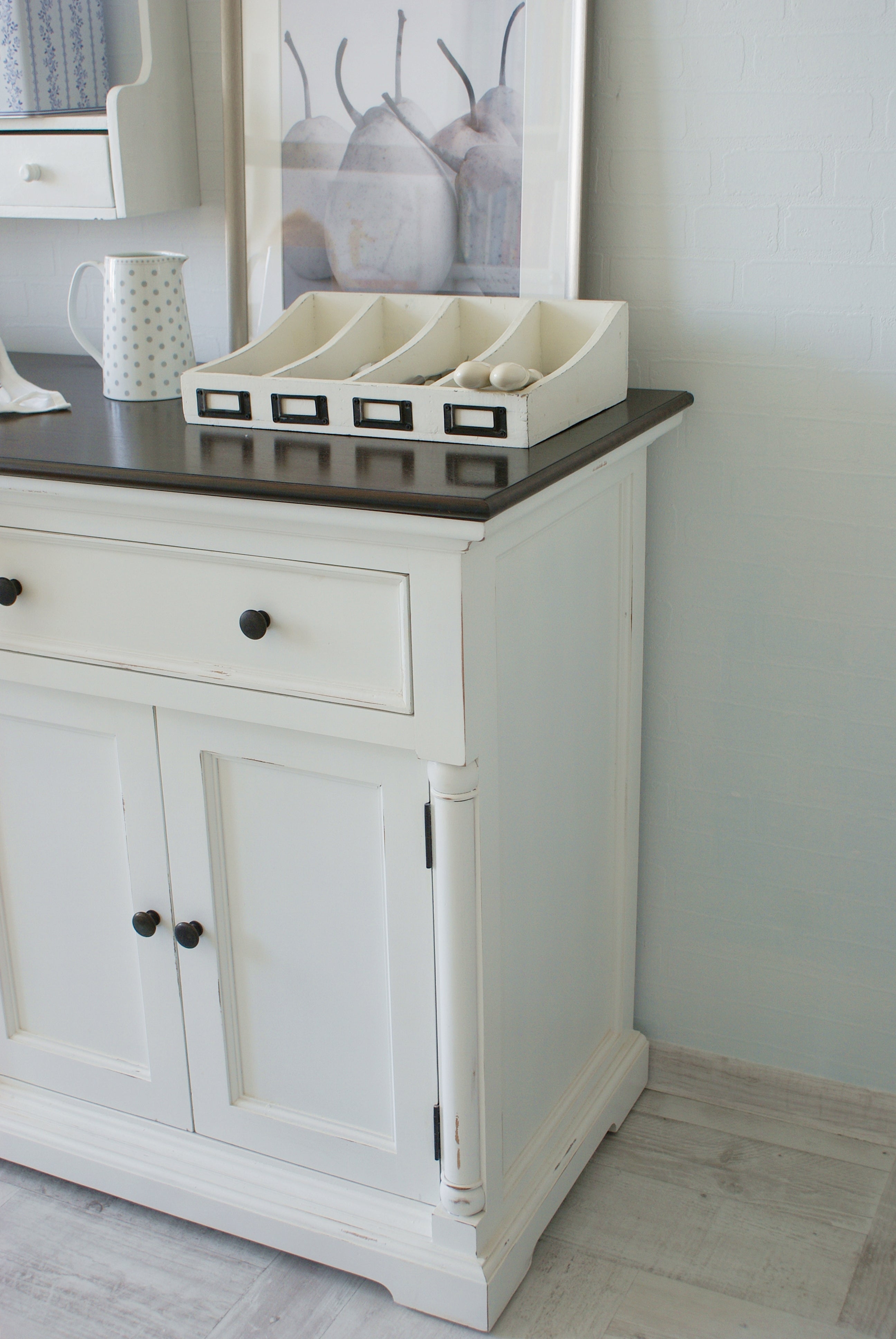 Close-up of the Provence Accent Classic Buffet showing a dark timber top, white painted side panel and styled storage tray.