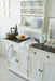 Close-up of the Provence Accent Classic Buffet with wall plate rack, dark timber top and styled kitchen accessories.