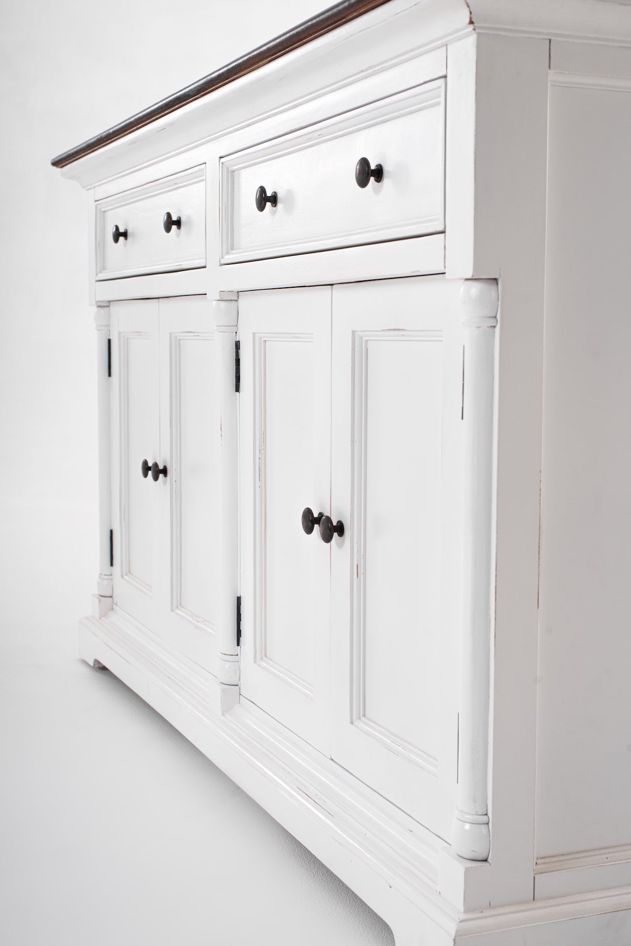 Angled close-up of the Provence Accent Classic Buffet showing white painted drawers, cupboard doors and dark round handles.