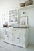 Provence Accent Classic Buffet styled in a light coastal kitchen with dark timber top, white painted base and matching wall plate rack.