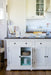 Provence Accent Classic Buffet used as a kitchen island with one cupboard door open to show internal storage.