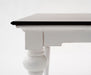 Side detail of the Provence Accent Dining Table with dark timber top, white painted apron and turned leg.