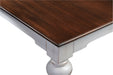 Close-up corner detail of the Provence Accent Dining Table showing the dark timber top, white painted frame and distressed finish.