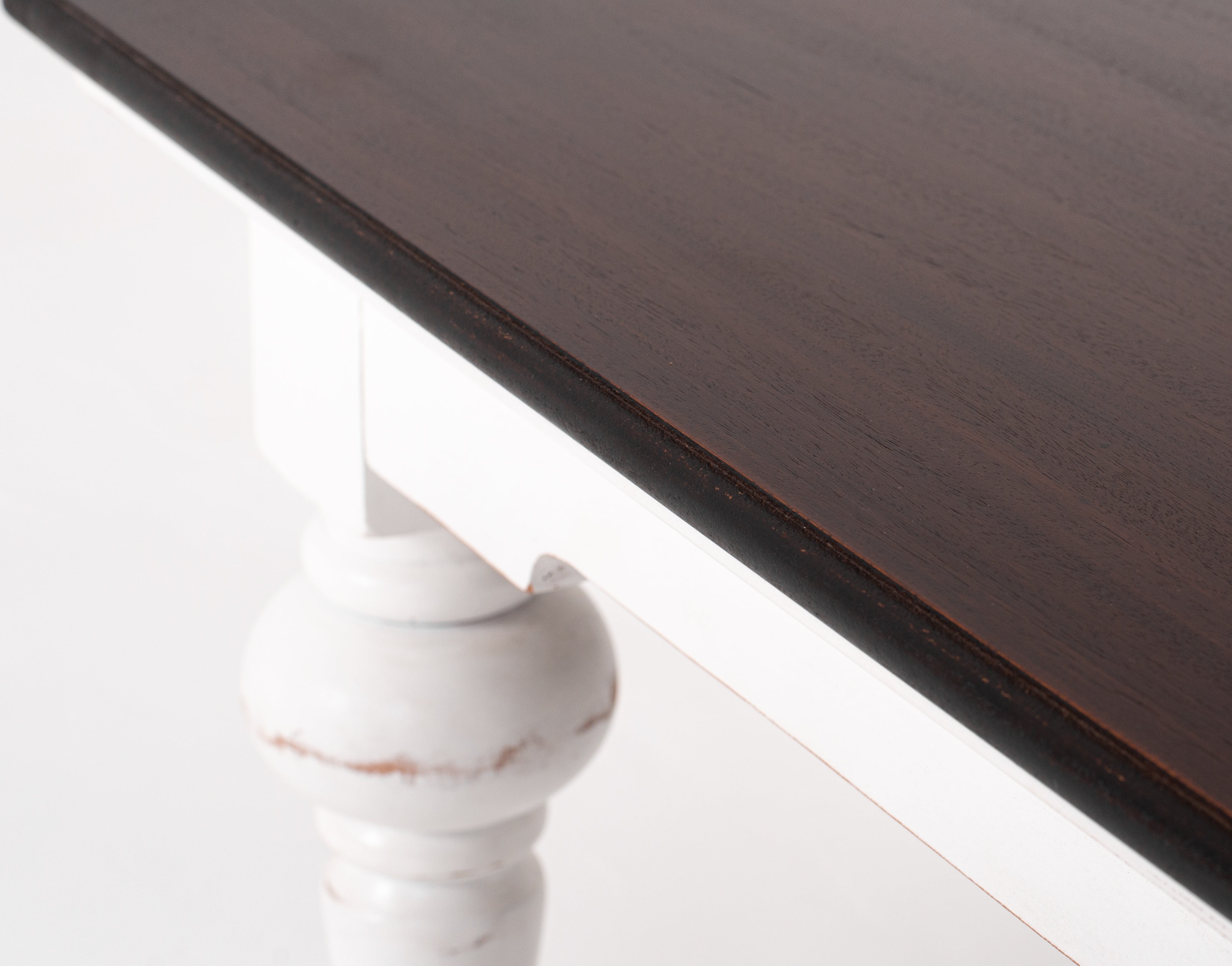 Close-up of the Provence Accent Square Coffee Table showing the dark timber edge, white painted frame and turned leg detail.