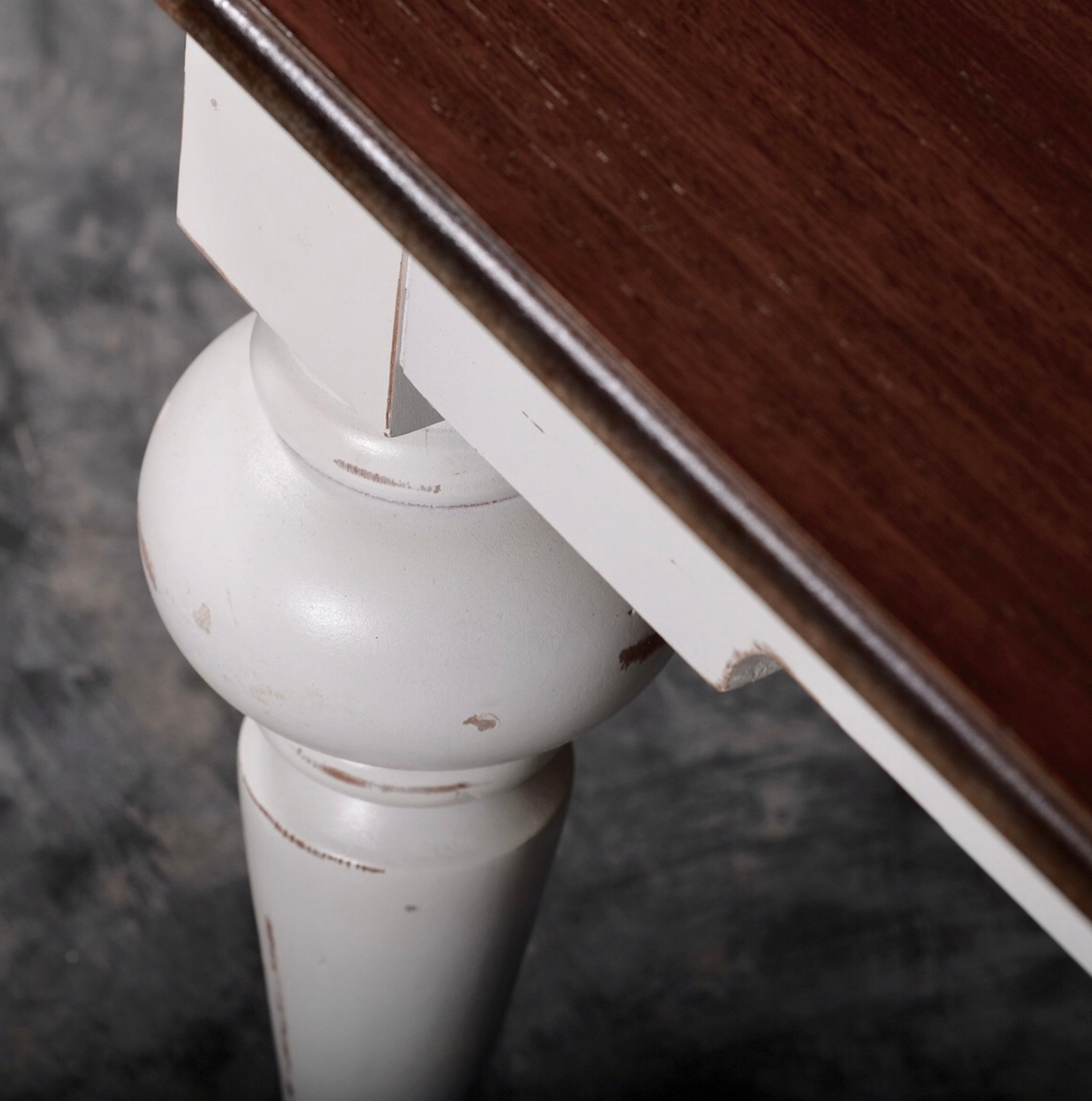 Close-up of the Provence Accent Square Coffee Table showing the dark timber top and white turned leg with a distressed finish.