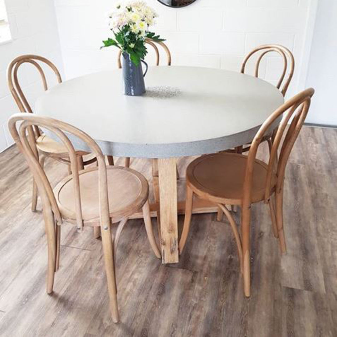 Replica Bentwood Chairs in weathered oak paired with a round dining table in a relaxed casual dining space.
