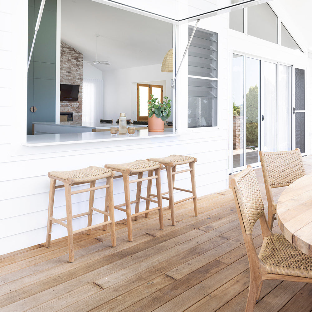 Outdoor serving window with three Zen Backless Bar Stools – Sand – Open Weave on timber deck, styled with indoor-outdoor living in mind.
