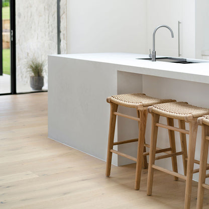 Kitchen corner featuring Zen Backless Bar Stools – Sand – Open Weave beneath a crisp white bench top and matte fittings.