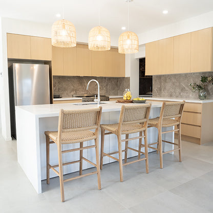 Stylish kitchen with Zen Counter Stools – Sand – Close Weave lined up under a stone bench top, blending seamlessly with timber cabinetry.