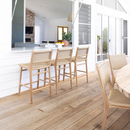 Outdoor entertaining area with Zen Counter Stools – Sand – Close Weave at a white servery window, styled on timber decking for relaxed alfresco dining.