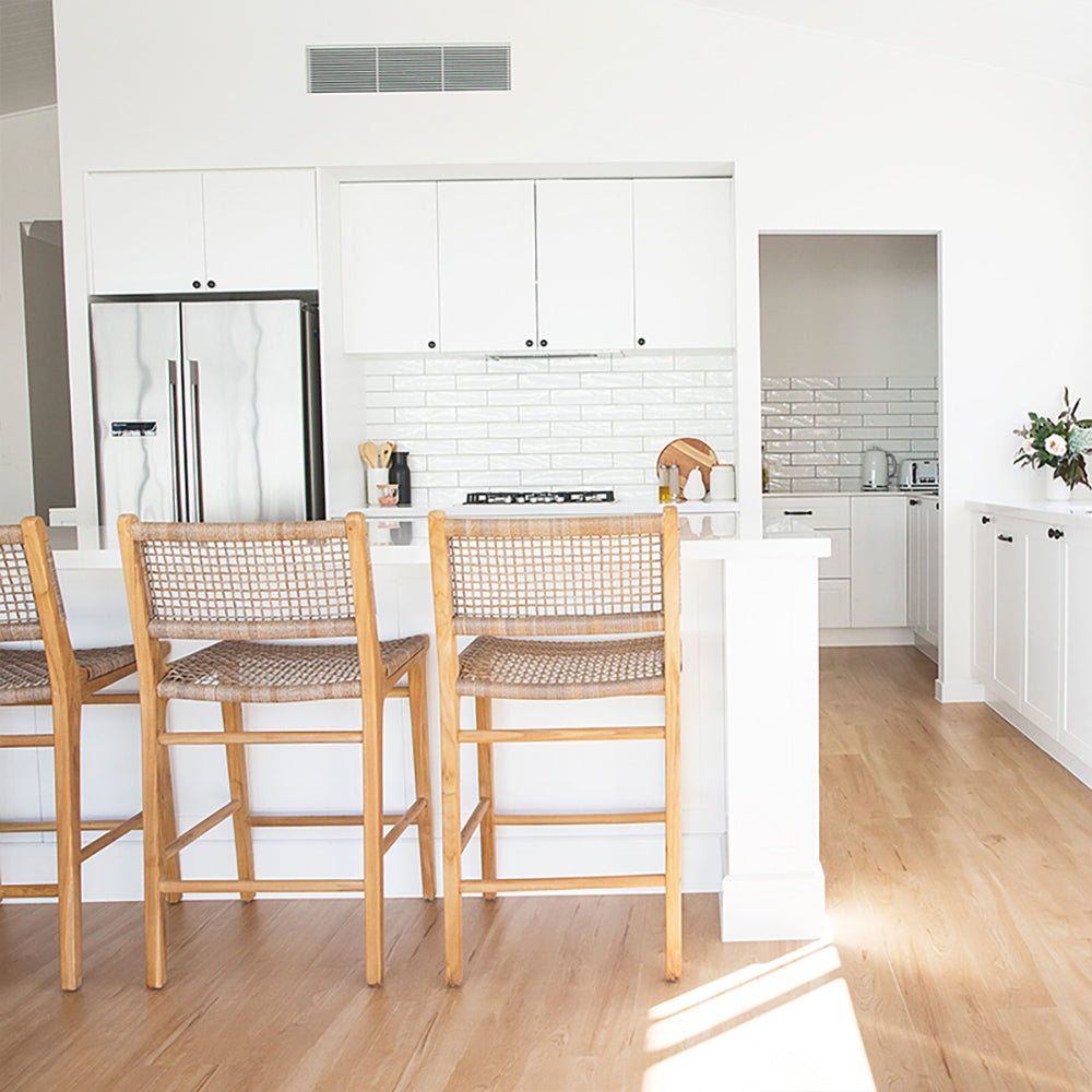 Bright modern kitchen with Zen Bar Stools – Washed Grey – Open Weave lined up at the counter for a coastal-inspired look.
