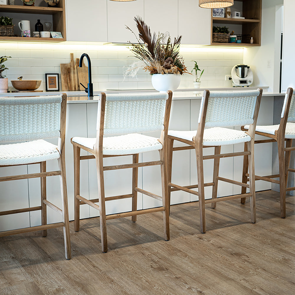 Rear angled view of Zen Counter Stools – White – Close Weave in a modern kitchen setting, showing woven backrests and teak framing.