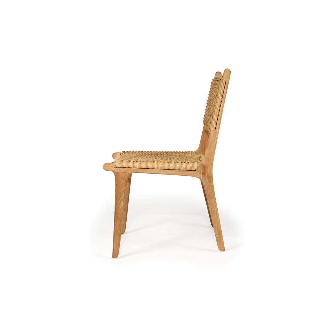 Side profile of Zen Dining Chair – Sand – Close Weave showcasing the gentle curve of the legs and ergonomic seat design.