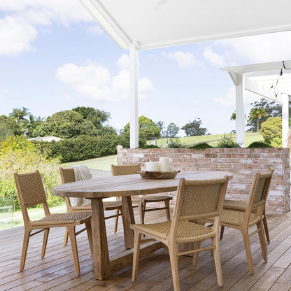 Outdoor patio setting featuring Zen Dining Chair – Sand – Close Weave around a round teak dining table on timber decking.