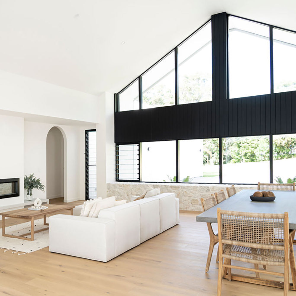 Interior lifestyle scene featuring the Zen Dining Chair – Washed Grey – Open Weave in a bright open-plan living and dining space.