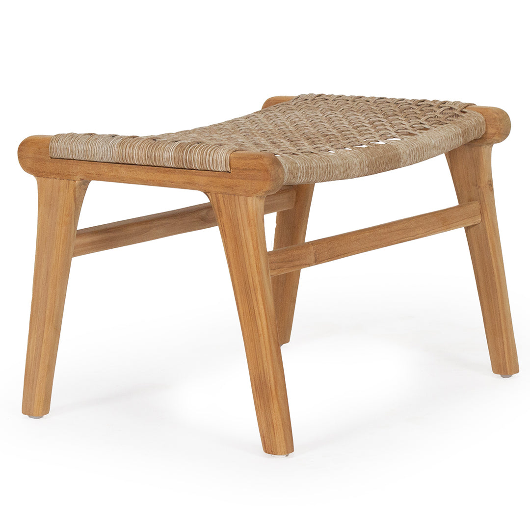 Angled front perspective of the Zen Lazy Chair Ottoman in Washed Grey, featuring a handwoven open weave rope seat in a warm tan color, supported by a sculpted mid-century teak wood frame with crossbar reinforcements.