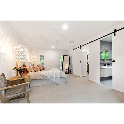 The Zen Lazy Chair – Washed Grey – Close Weave placed in a serene master bedroom with soft lighting, a neutral bedspread, and timber accents. The chair enhances the space’s relaxed, minimalist style with its curved teak frame and textural rope backrest.