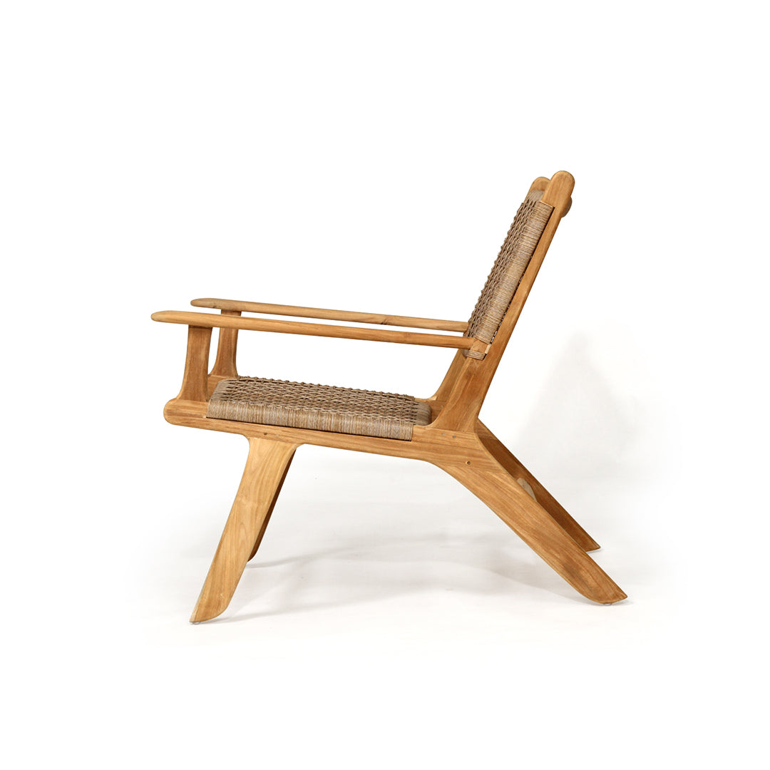 Side profile of the Zen Lazy Chair - Sand - Open Weave, highlighting its reclined silhouette with curved teak legs and a breathable rope seat and back for ergonomic and stylish outdoor comfort.