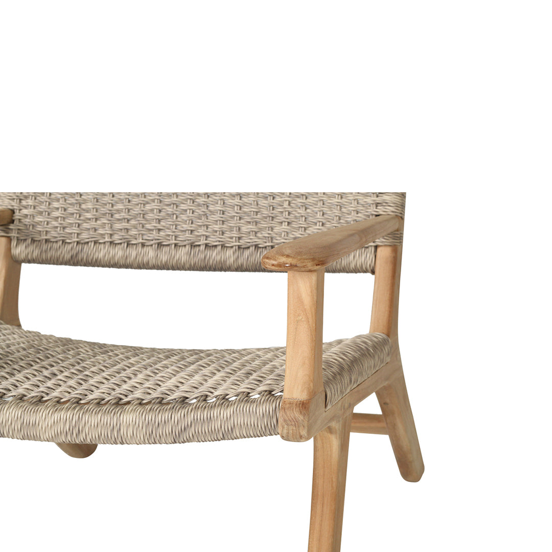Partial close-up of the front right corner of the Zen Lazy Chair - Sand - Close Weave, focusing on the handwoven seat and mid-height armrest crafted from solid teak with a natural finish.