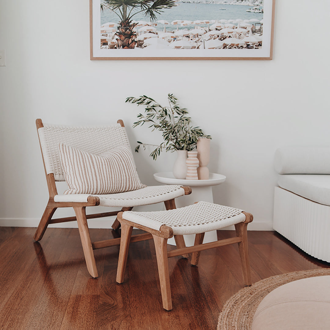 Zen Lazy Chair - White - Open Weave paired with its matching ottoman, styled in a minimalist white interior. The duo sits beside a sculptural white side table with textured ceramic vases and greenery, emphasizing the chair’s versatility for modern coastal living spaces.