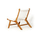 Angled rear-side perspective of the Zen Lazy Chair - White - Open Weave, featuring a solid teak frame with tapered legs and a curved seat and backrest made from handwoven open-weave white cord.