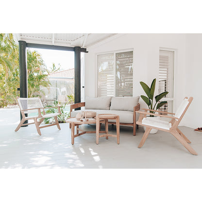 Stylish outdoor seating arrangement with the Zen Lazy Chair - White - Open Weave placed around a teak love seat and round side tables; chairs feature airy grid-patterned rope weaving and natural teak frames, ideal for coastal or bohemian outdoor decor.