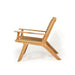 Side profile of Zen Lazy Chair – Sand – Close Weave with arms, featuring sculpted teak base and ergonomic woven design.