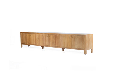 Angled front view of the Audrey Entertainment Unit, Natural, 300cm, with fluted cabinet doors, brass handles and natural timber finish.