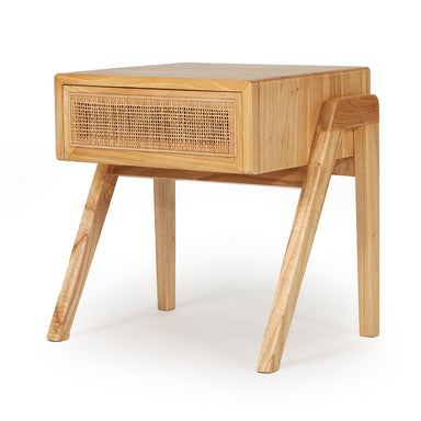 Angled view of the Castaway Bedside Table with natural timber frame, rattan drawer and tapered legs