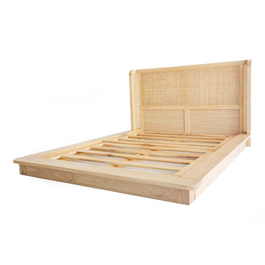 Angled view of the Castaway Queen Bed natural timber platform frame with slat base and rattan headboard