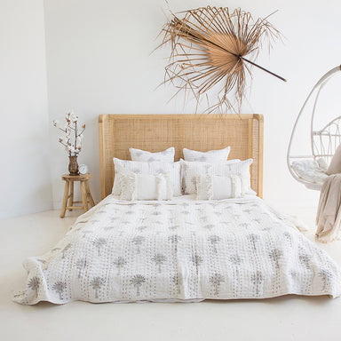 Castaway Super King Bed styled in a bright bedroom with natural timber frame, rattan headboard and white bedding