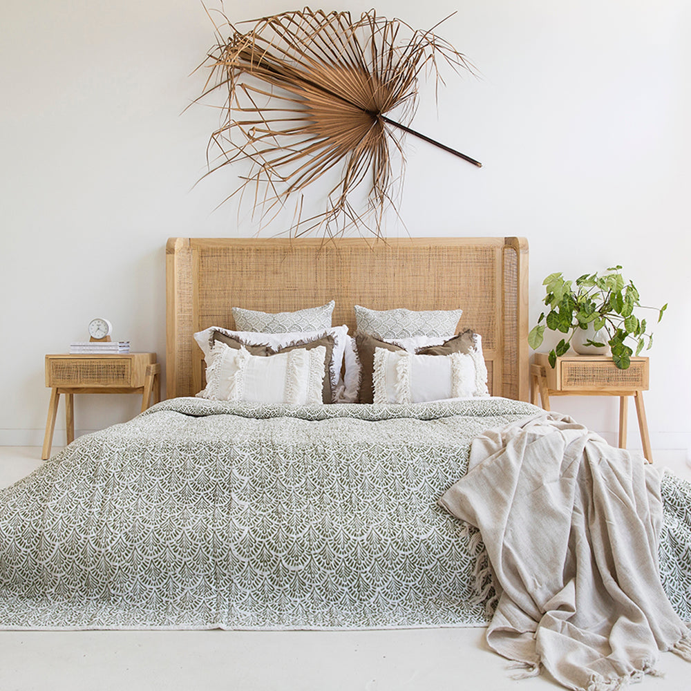 Castaway Super King Bed styled with green patterned bedding, natural timber frame and rattan headboard