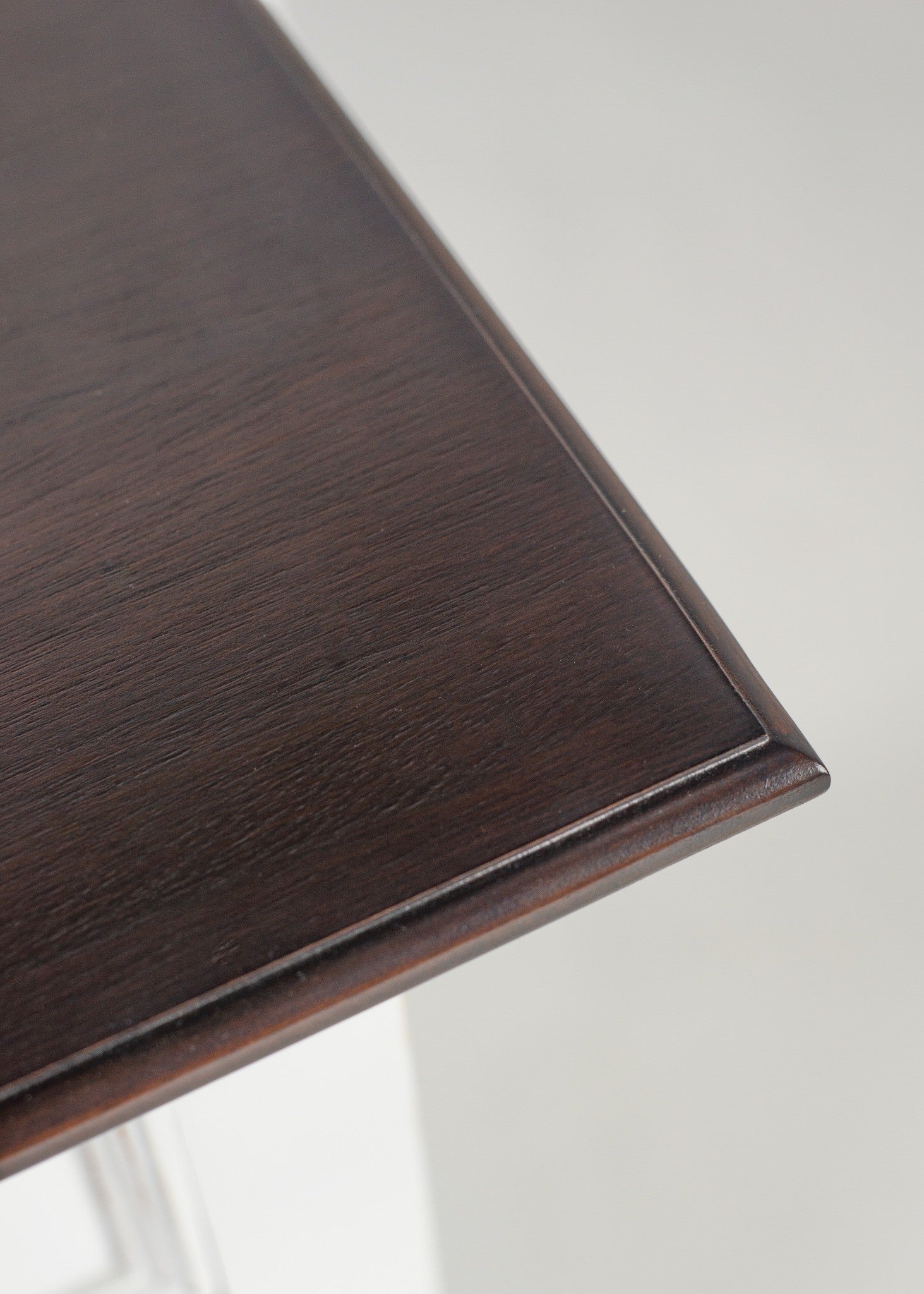 Halifax Accent Buffet close-up of dark timber top with rounded edge and visible wood grain, contrasting white coastal buffet cabinet.