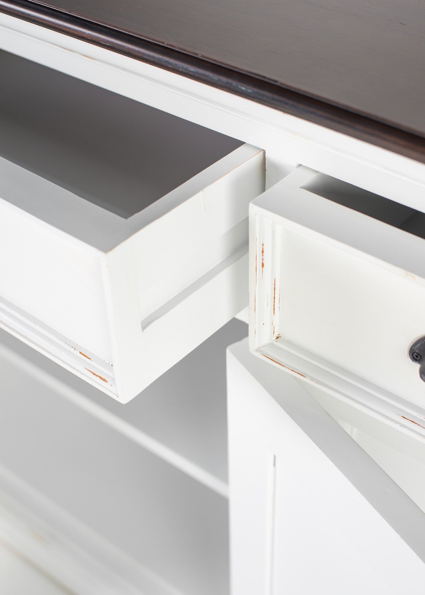Halifax Accent Buffet close-up of open drawers, white distressed finish and dark timber top, showing sideboard storage detail.