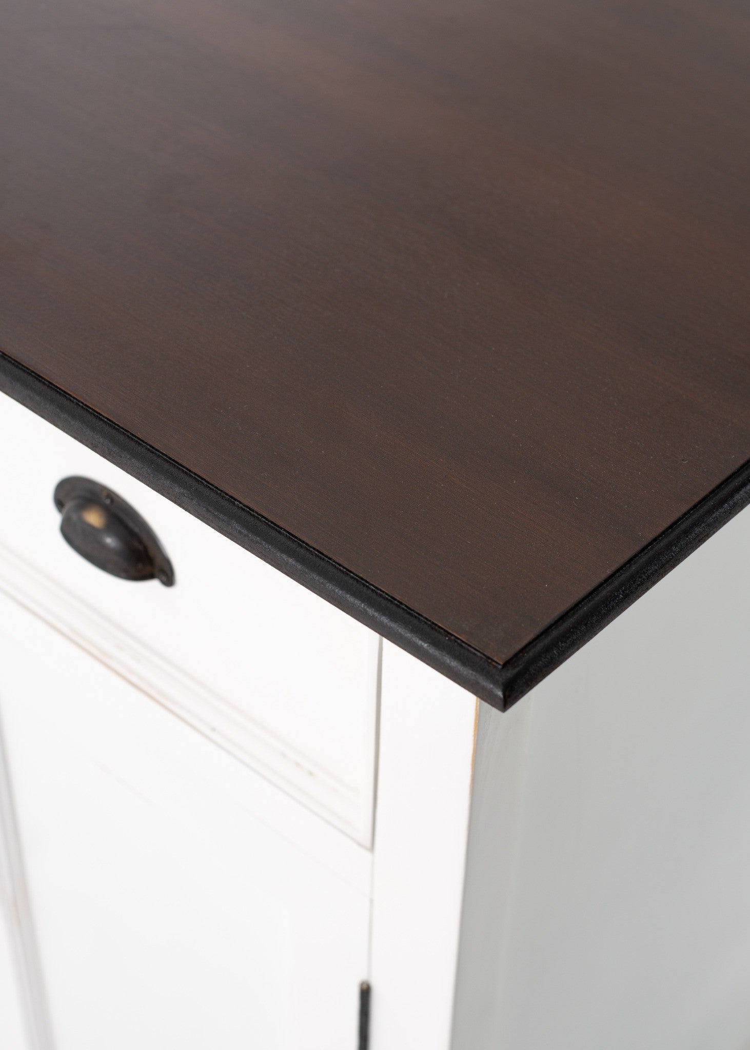 Halifax Accent Buffet with 2 baskets close-up of dark timber top, black edge trim and white painted cabinet detail.