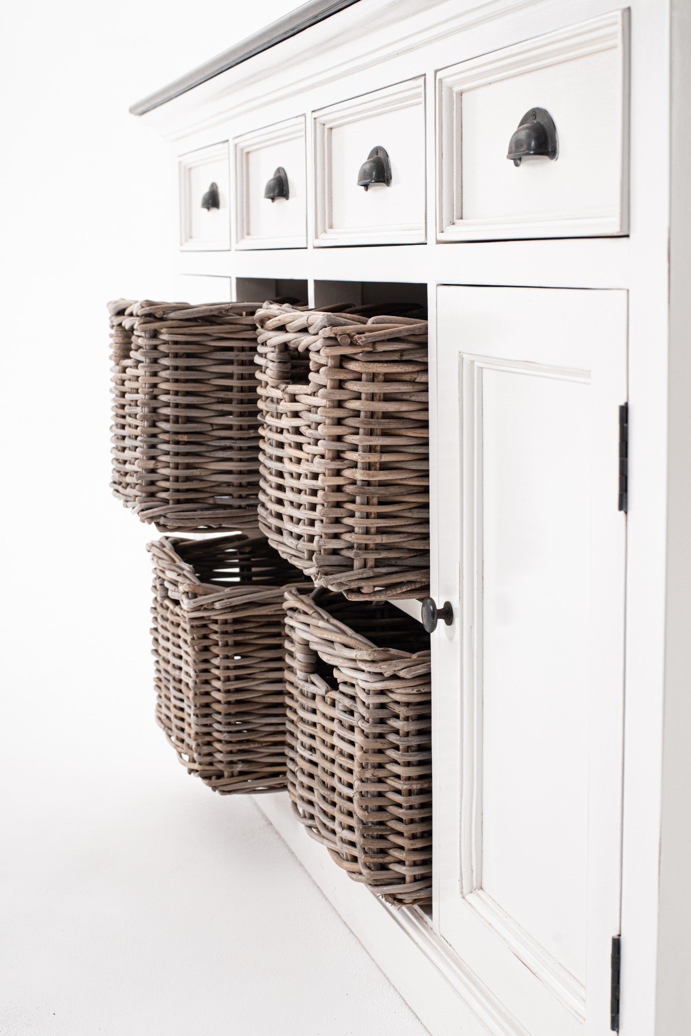 Halifax Accent Buffet with 4 baskets angled detail showing woven rattan basket storage, white painted cabinet doors and antique black drawer handles.