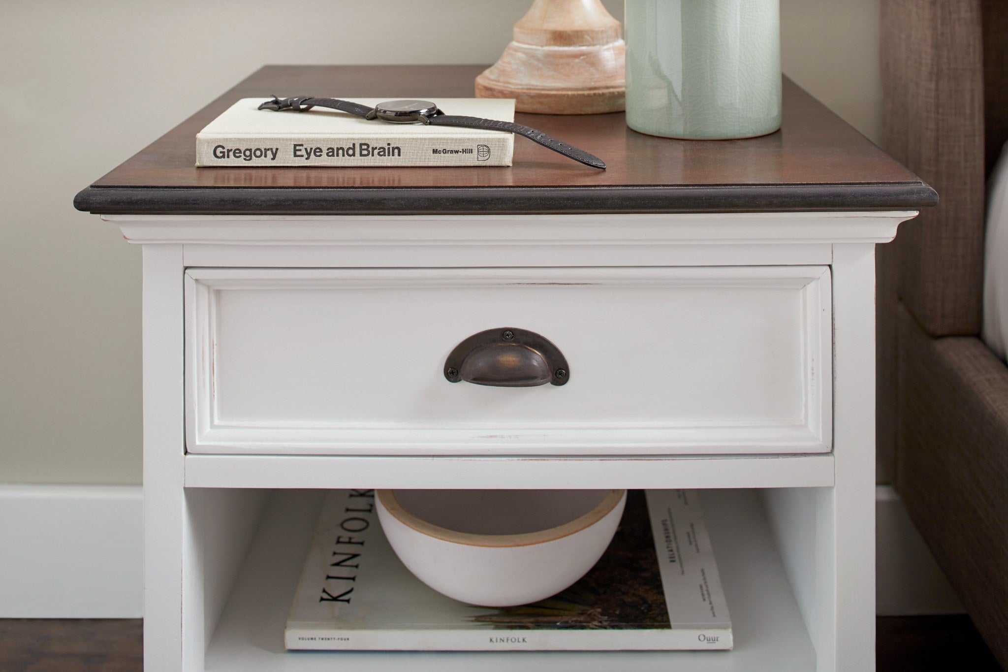 Close-up of Halifax Accent white bedside table drawer with dark timber top and antique cup pull
