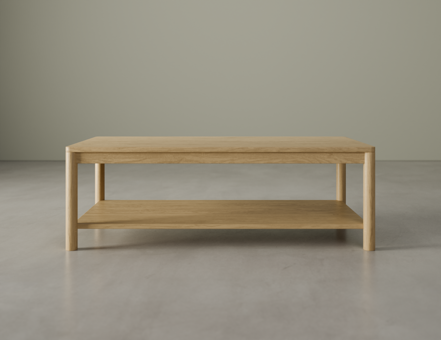 Front view of rectangular wooden coffee table in natural oak finish on a polished concrete floor.