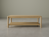Front view of rectangular wooden coffee table in natural oak finish on a polished concrete floor.