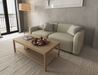 Rectangular wooden coffee table in natural oak finish next to a 2 seater beige couch and tall lamp on a natural rug.