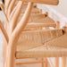 Wishbone Counter Stool in Natural Oak close up of the woven cord seat and curved timber frame beside a white kitchen bench.