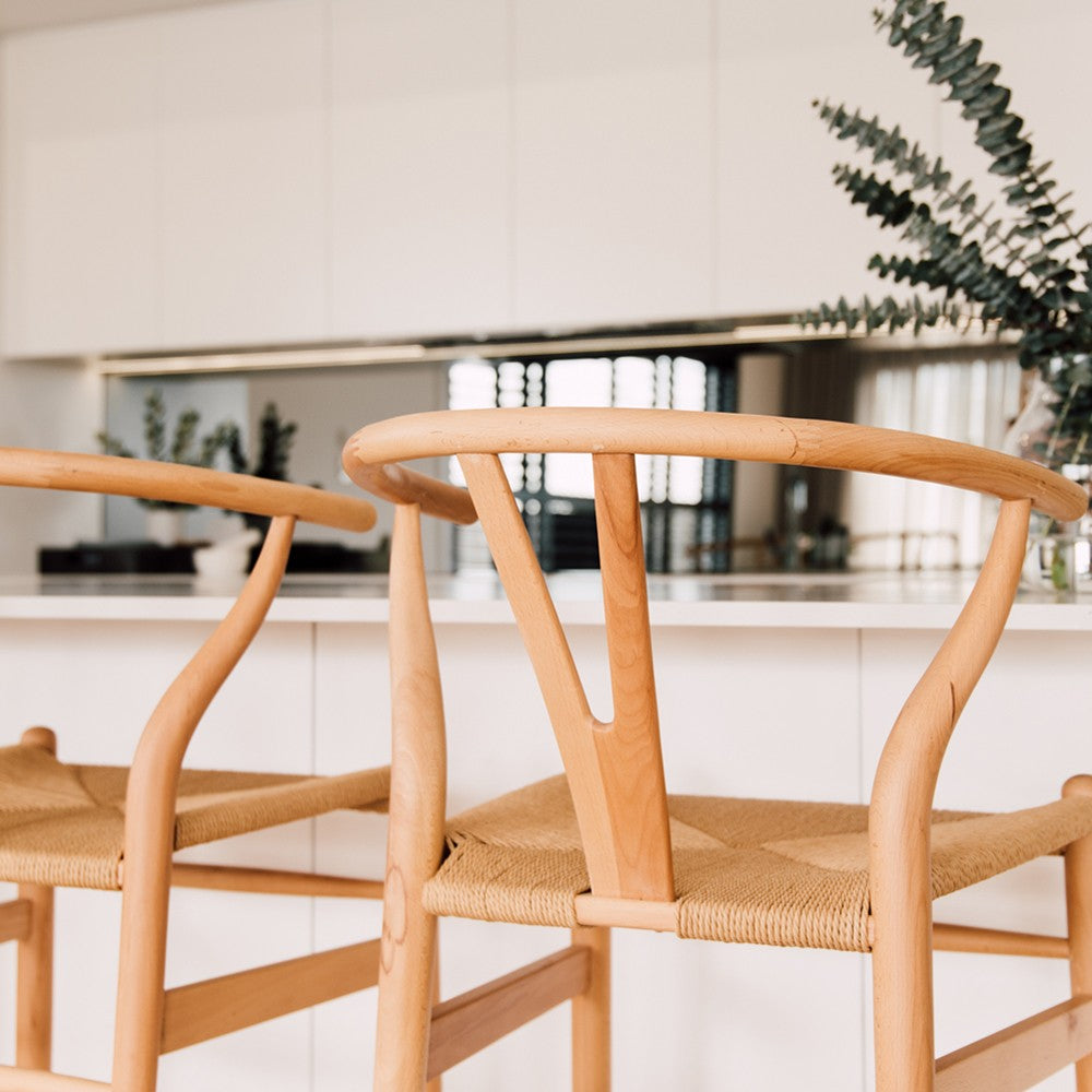 Wishbone Counter Stool in Natural Oak close up of the curved wishbone backrest, smooth timber frame and woven cord seat.