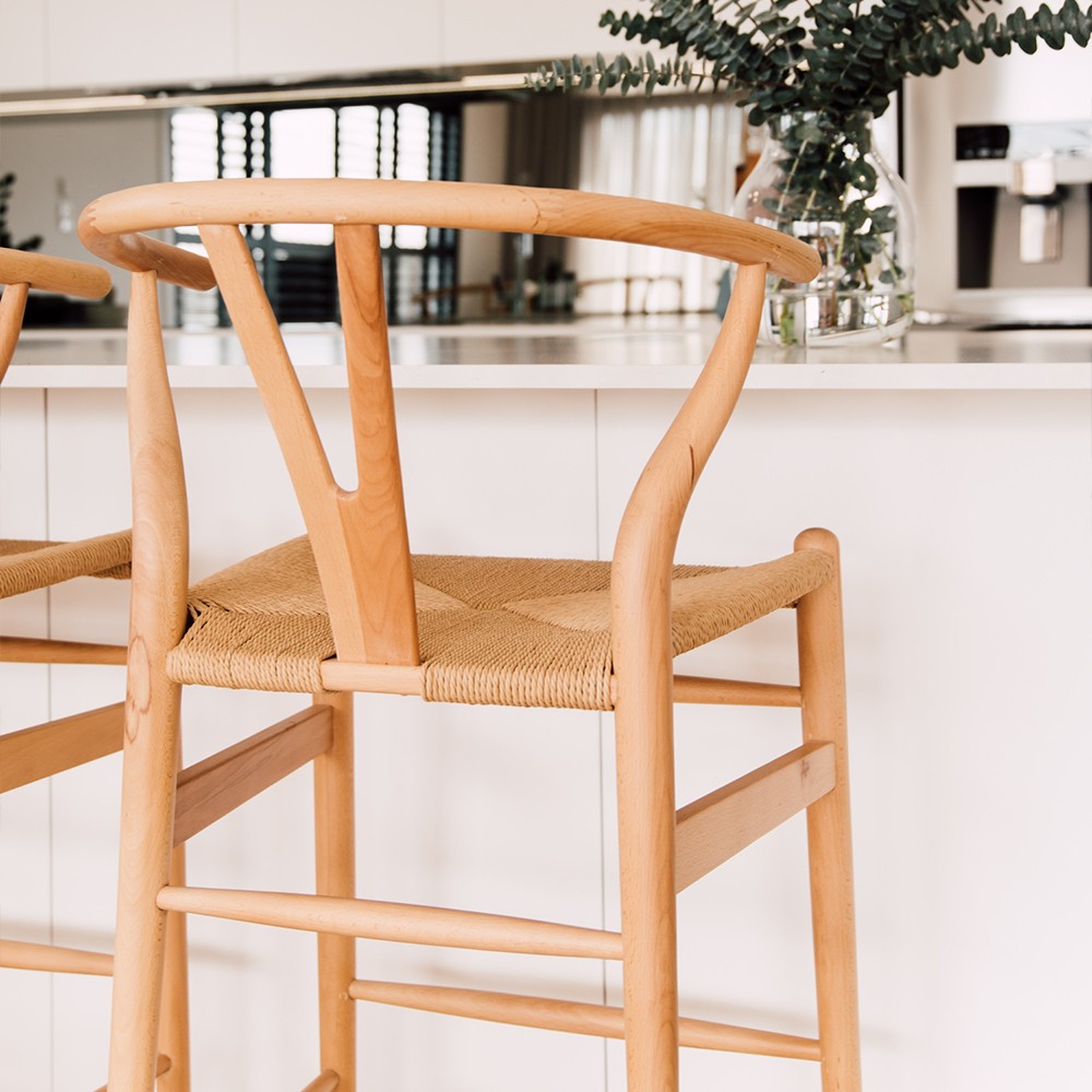 Wishbone Counter Stool in Natural Oak close up showing the rounded backrest, Y-shaped support and handwoven natural cord seat.