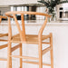 Wishbone Counter Stool in Natural Oak close up showing the rounded backrest, Y-shaped support and handwoven natural cord seat.