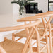 Wishbone Counter Stool in Natural Oak close up showing curved timber backrests and woven natural cord seats at a kitchen bench.